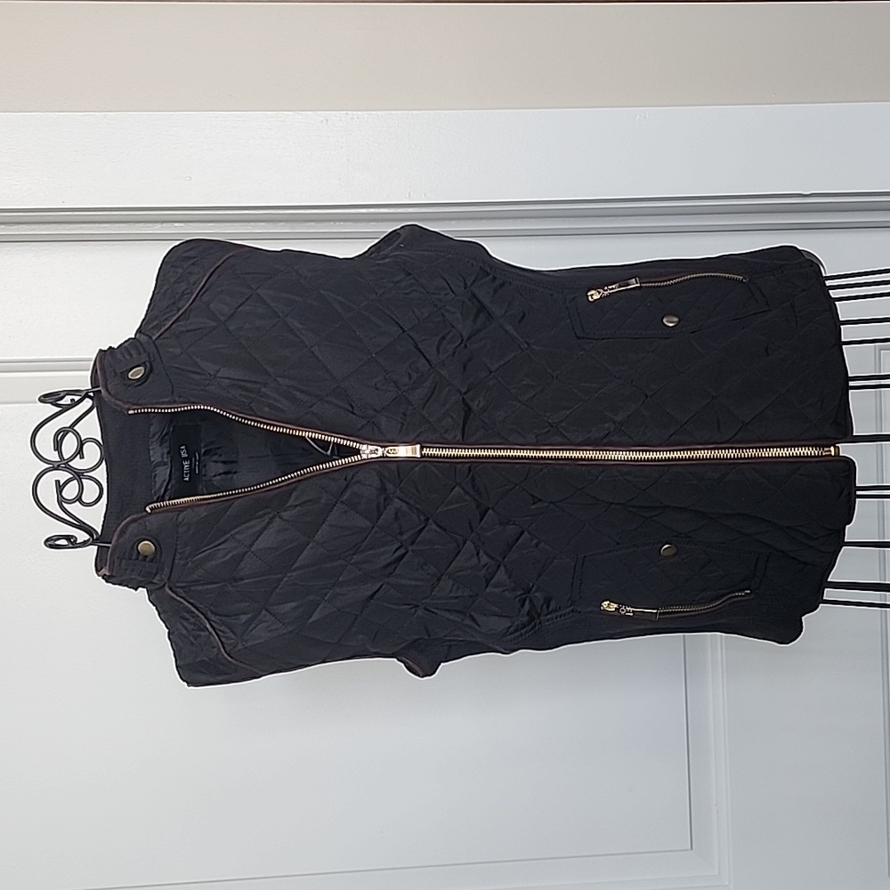 Black quilted vest with brown trim and gold zippers/buttons. Size small.